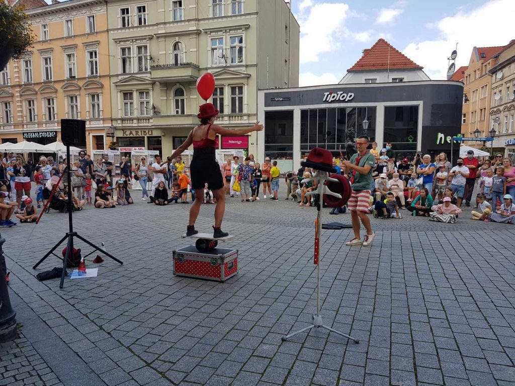 Busker Gaia Ma during street show at the International Festival of Street Art BuskerBus