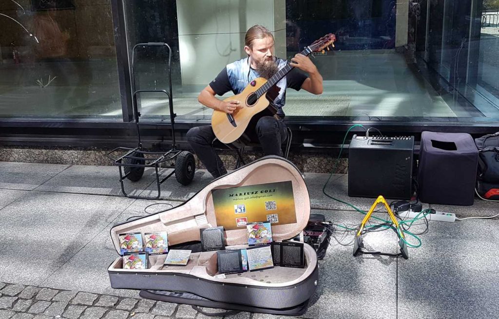 Street musician Mariusz Goli performing at BuskerBus in Wrocław