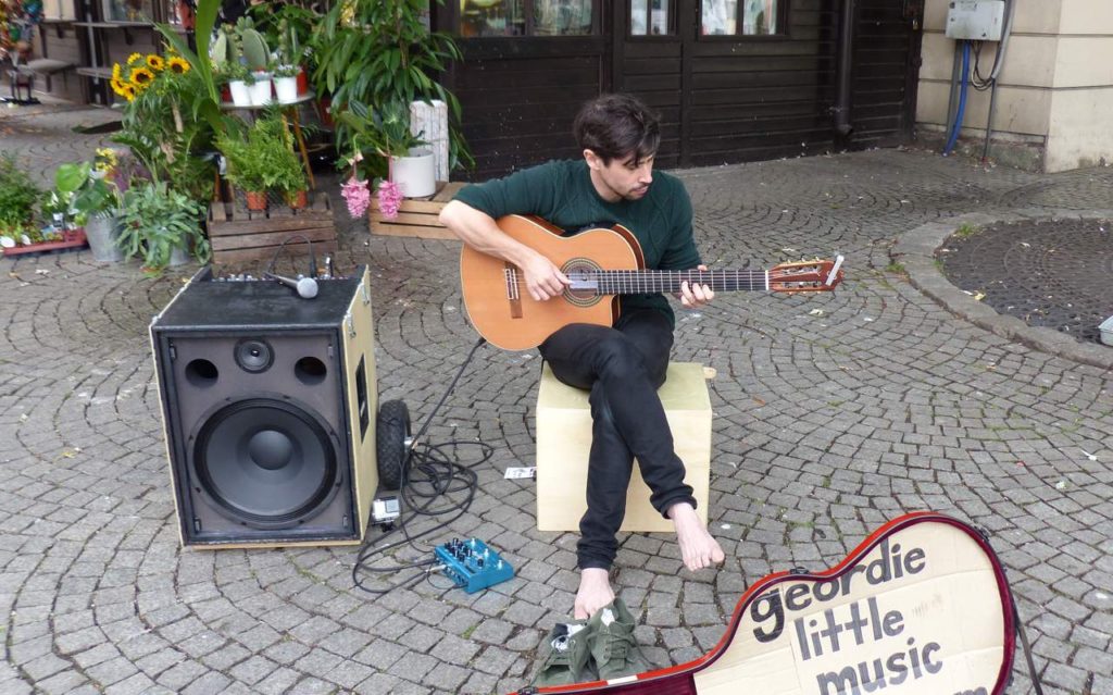 Guitarist Geordie Little performing at BuskerBus