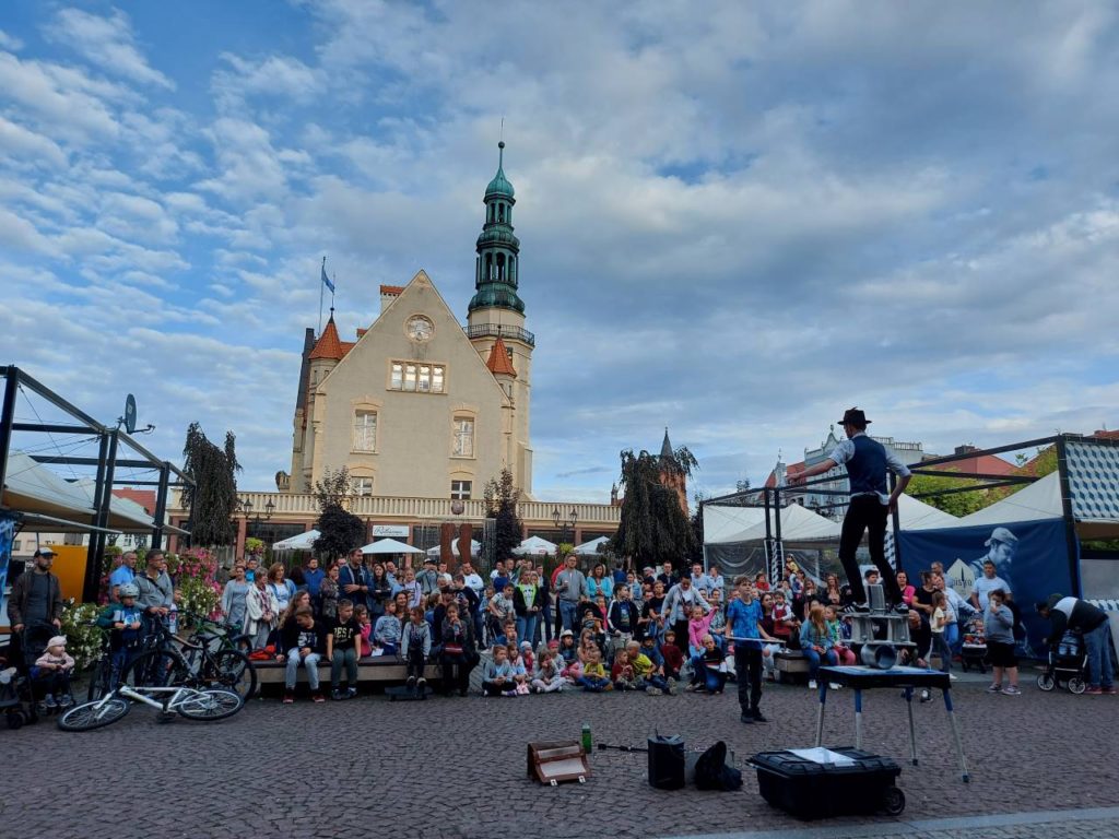 Busker Richard Filby balancing on rola bola in front of the town hall in Krotoszyn