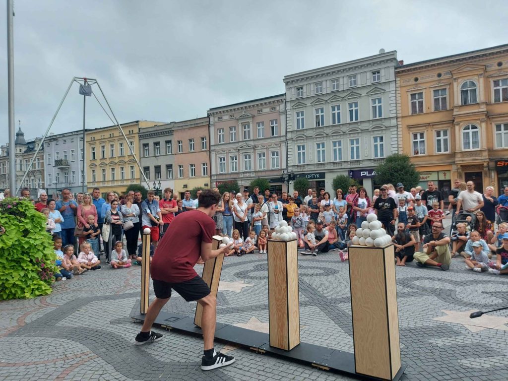 A crowd watching a street circus show.