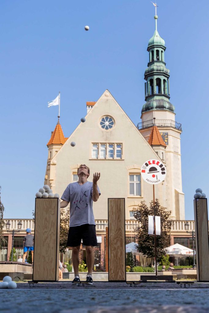 Performer Domenyk La Terra juggles in front of the town hall in Krotoszyn