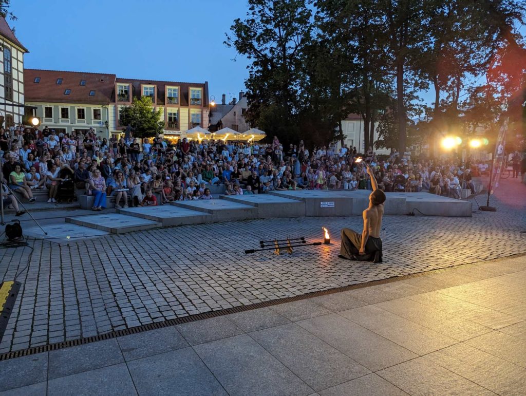 Street artist performing for a crowd in Zielona Góra