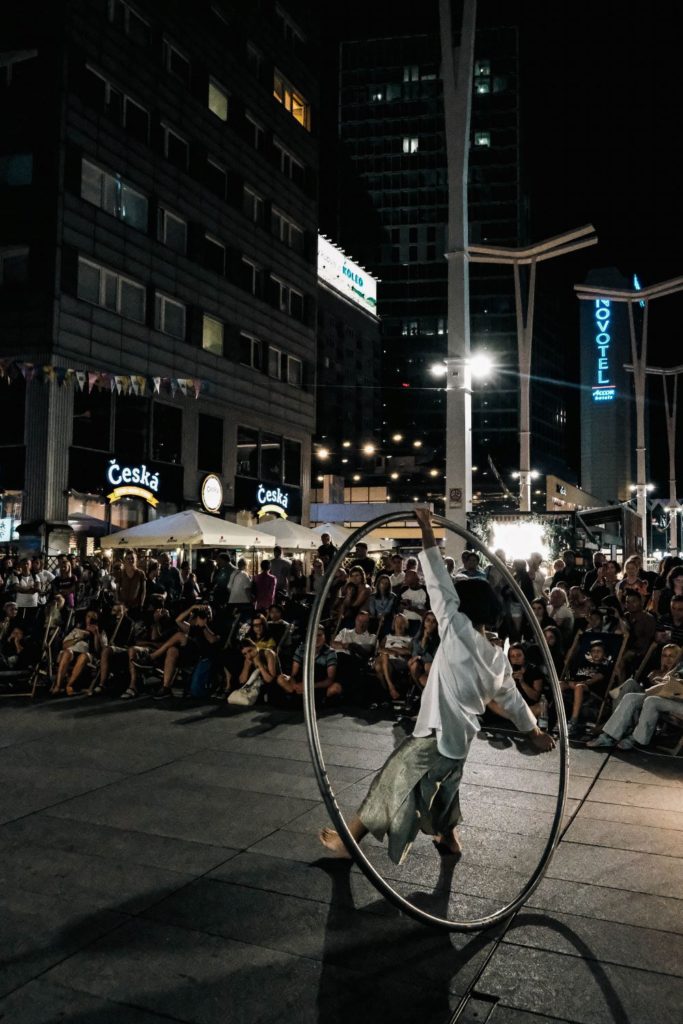 A crowd is watching a Cyr wheel performer